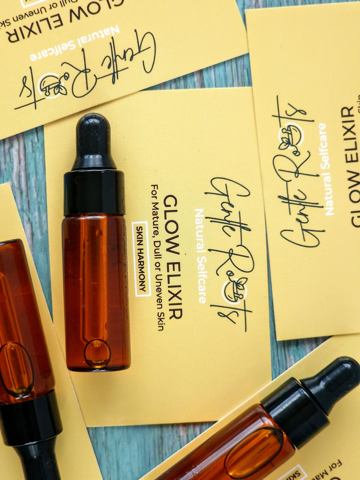 Mini Glow Elixir for mature, dull, uneven skin with yellow background card