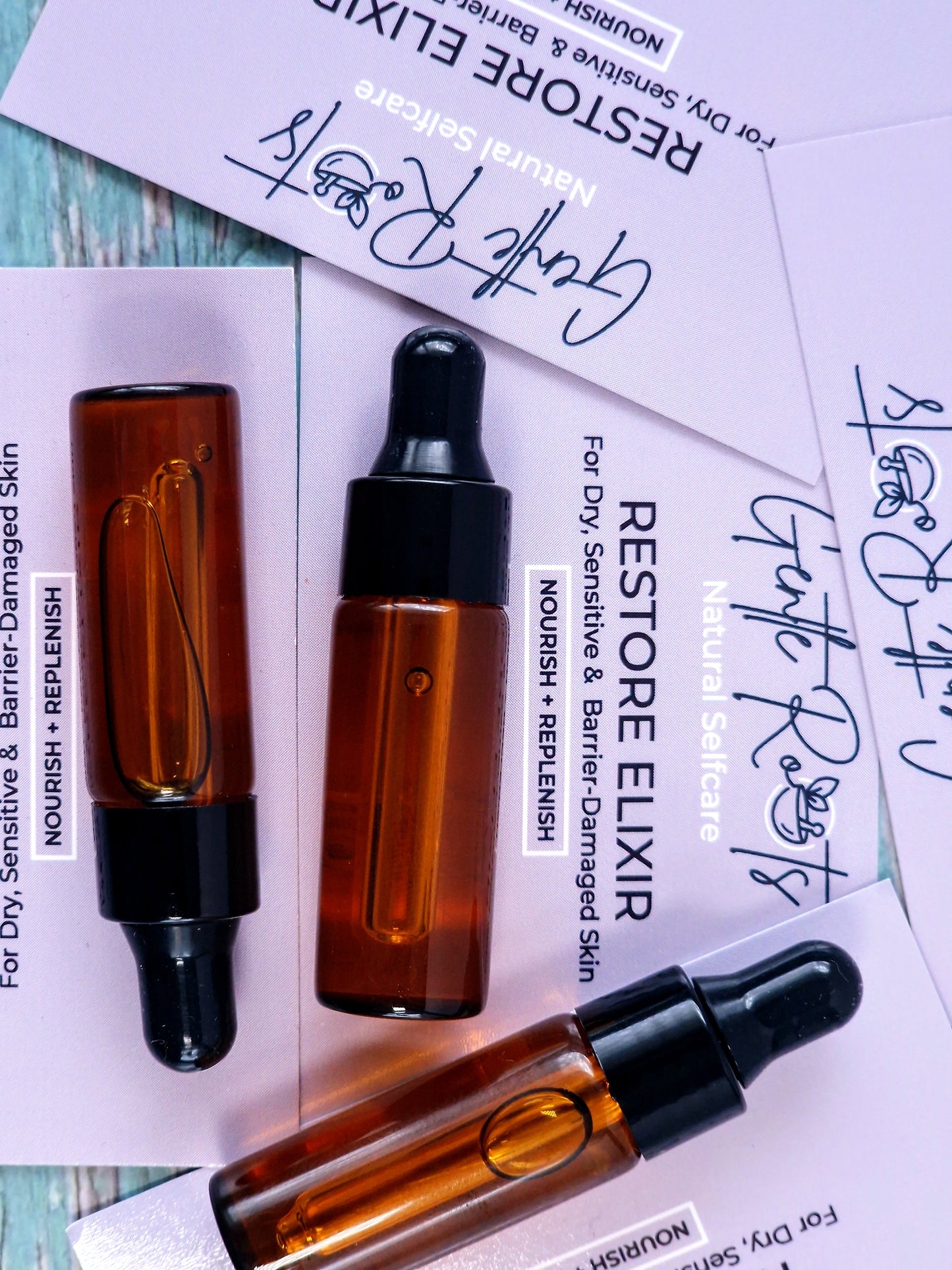 Mini Restore Elixir for dry,sensitive and barrier damaged skin with lilac packaging and background card