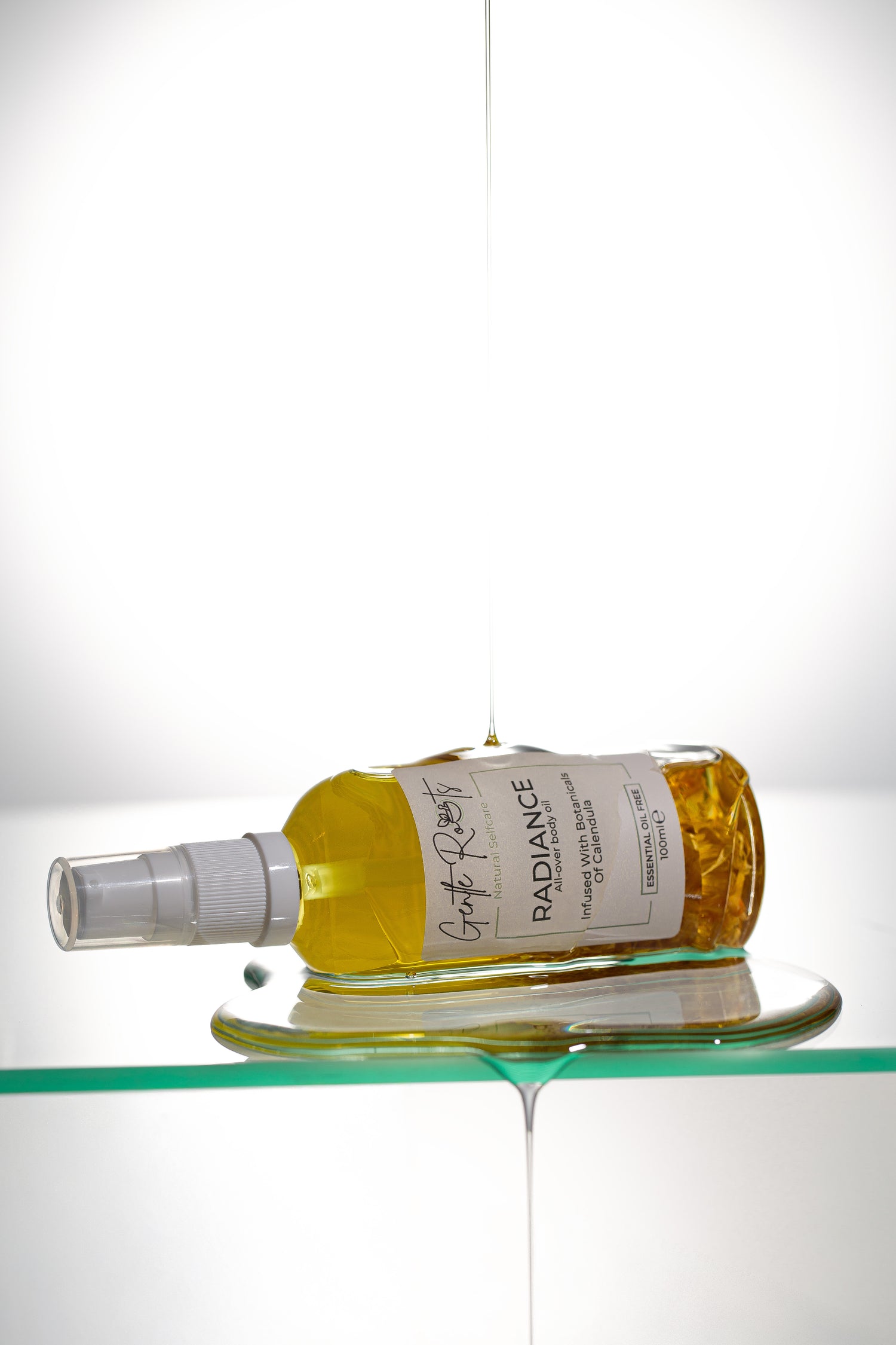 Gentle Roots Radiance Body Oil Unscented in glass bottle with botanical infusion texture shot