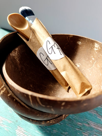 Gentle Roots coconut masking bowl with bamboo brush and spoon for mixing clay masks.