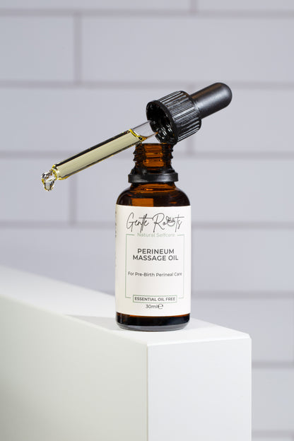Gentle Roots Perineum Massage Oil for pregnancy care in amber glass dropper bottle on white block