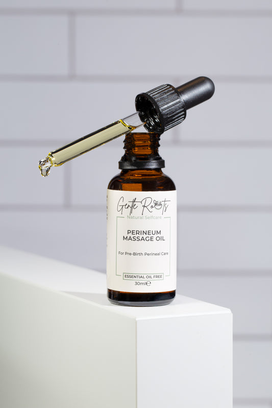 Gentle Roots Perineum Massage Oil for pregnancy care in amber glass dropper bottle on white block