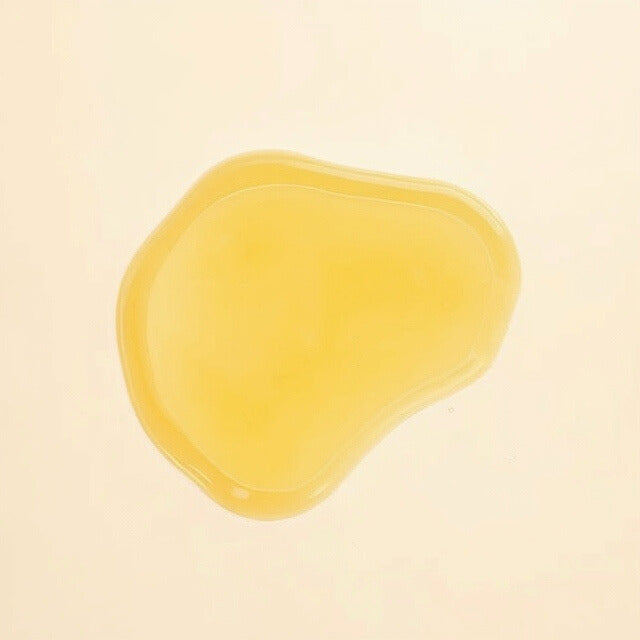 Golden drop of Gentle Roots Perineum Massage Oil showing silky texture