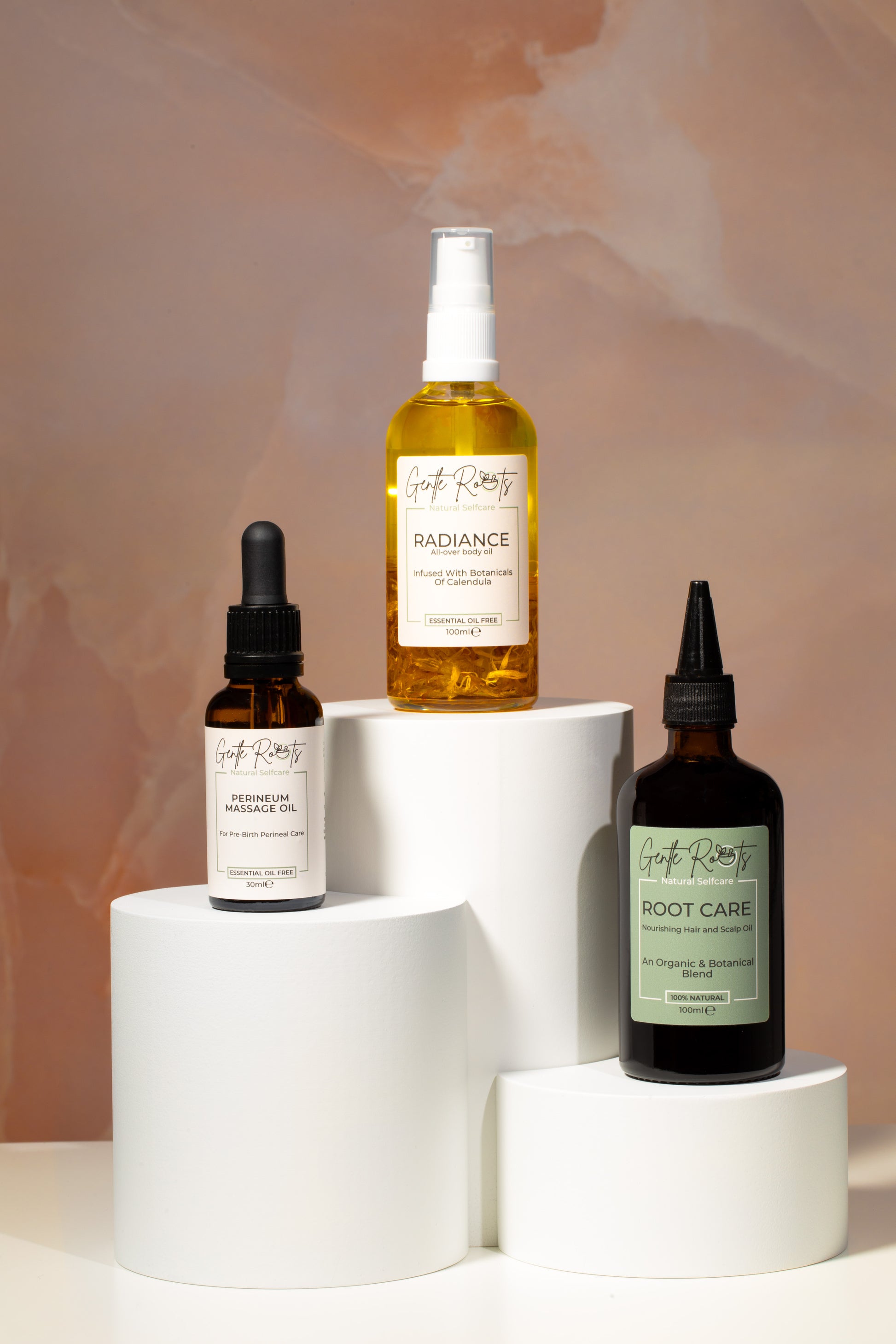 Gentle Roots Radiance Body Oil – glow boosting body oil with sweet orange and ylang ylang, shown with full skincare collection.