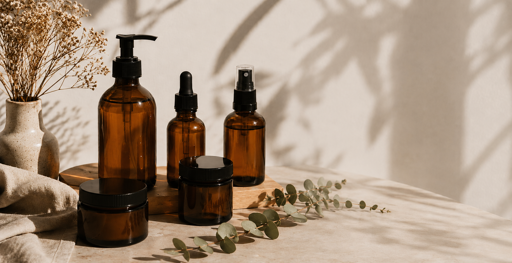 Collection of gentle roots amber glass bottles on a wooden surface with natural light and greenery.