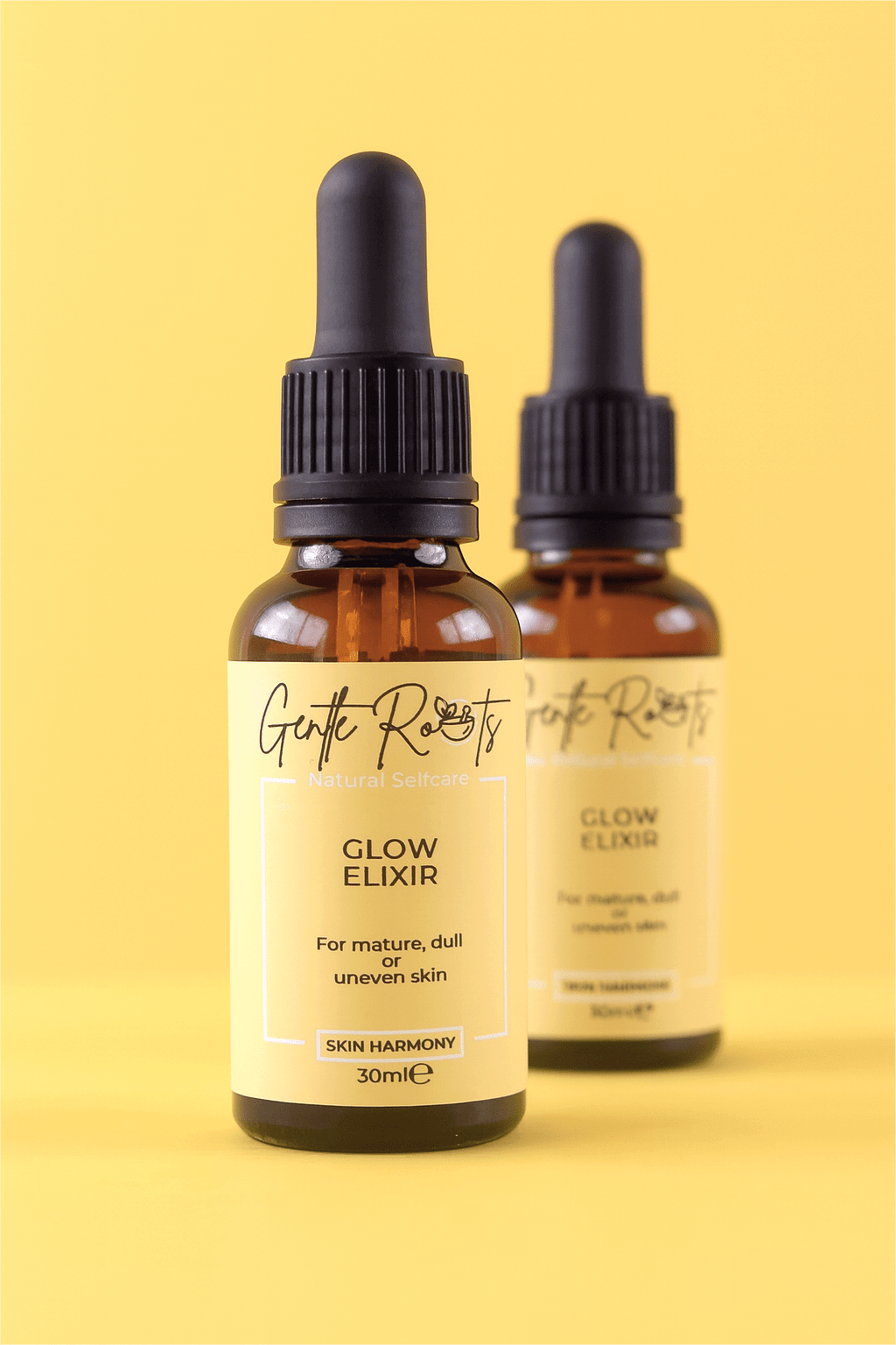 Two bottles of Gentle Roots Glow Elixir – natural brightening serum with sea buckthorn CO2 extract and rosehip seed oil.
