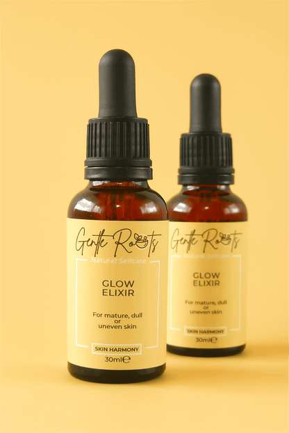Pair of Gentle Roots Glow Elixir bottles on a yellow background – vegan, non-toxic face oil for dull and uneven skin.