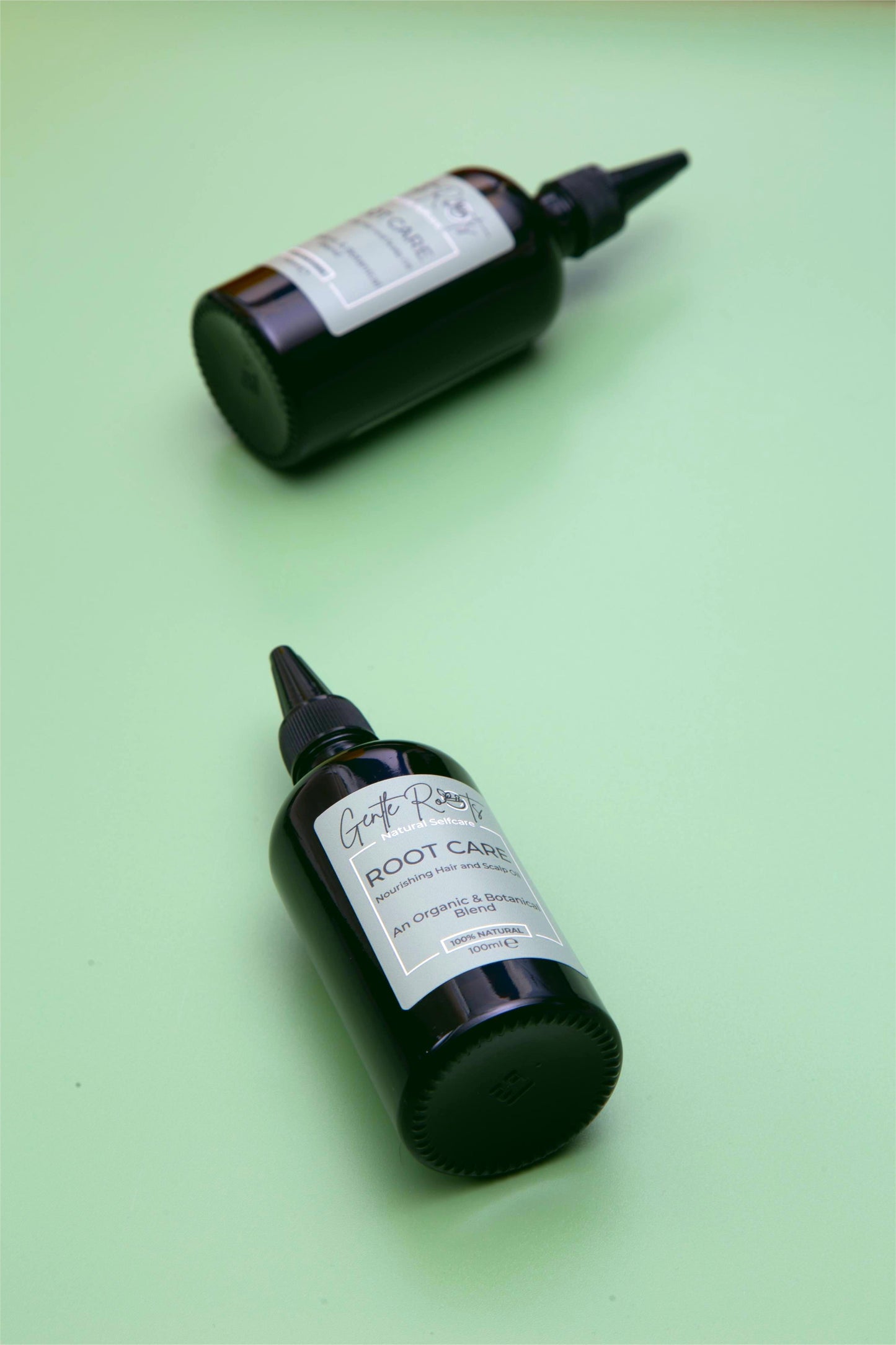 Root Care Hair & Scalp Oil flatlay on a green background – Gentle Roots